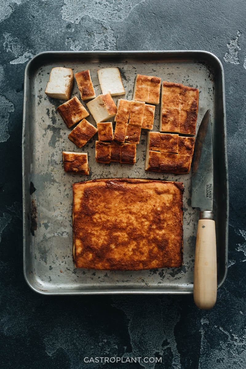 Easy baked tofu sliced on baking sheet