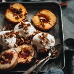 Square photo of roasted peaches with vegan vanilla ice cream and granola