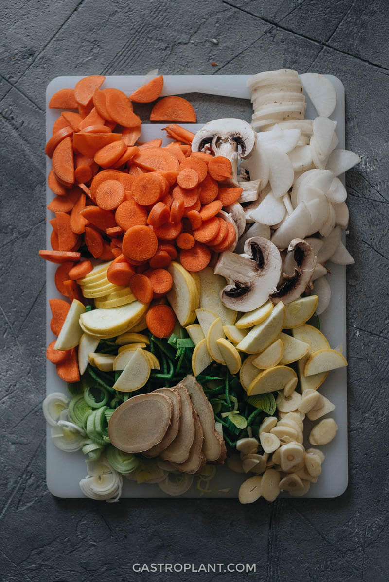 Chopped vegetables and herbs on a cutting board