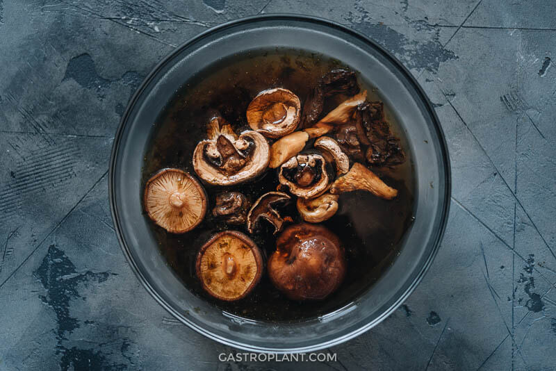 Mushrooms and seaweed soaking in a bowl for vegan dashi