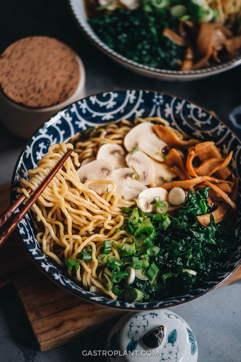 Pulling some ramen from a bowl of hot soy sauce broth