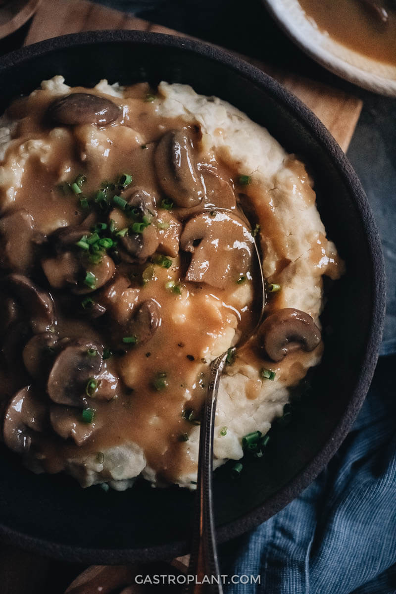 Vegan mashed potatoes topped with the BEST vegan mushroom gravy