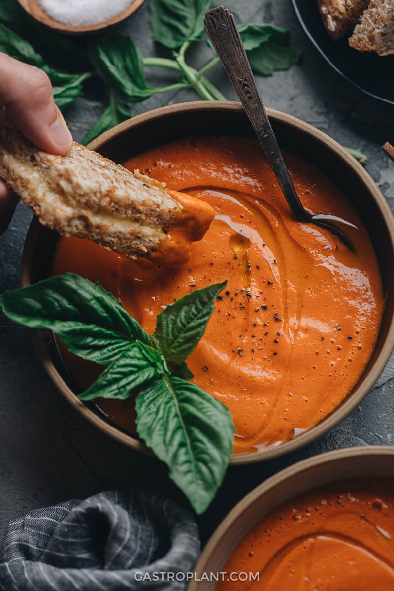 Super easy 4-ingredient vegan tomato soup with basil dipping grilled cheese sandwich in it