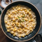 Vegan creamed corn in a black bowl