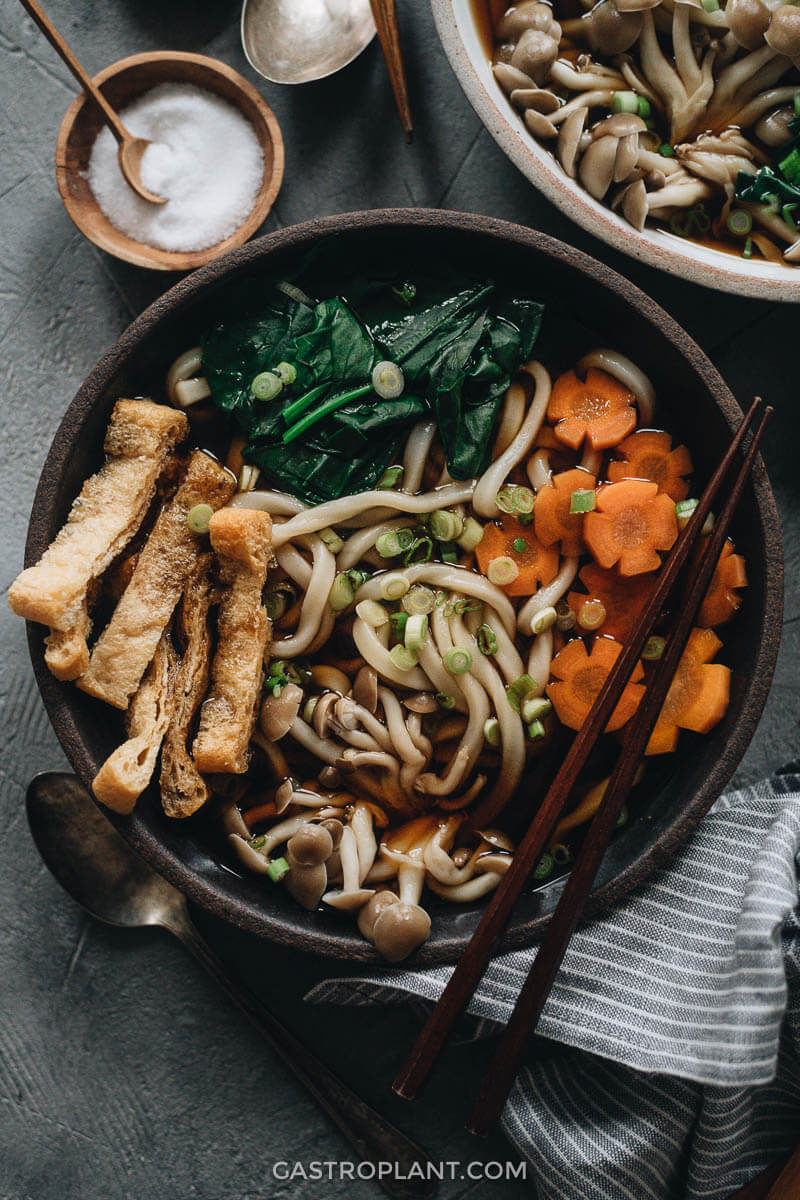 Vegan udon noodle soup with tofu, carrot, mushroom and broth