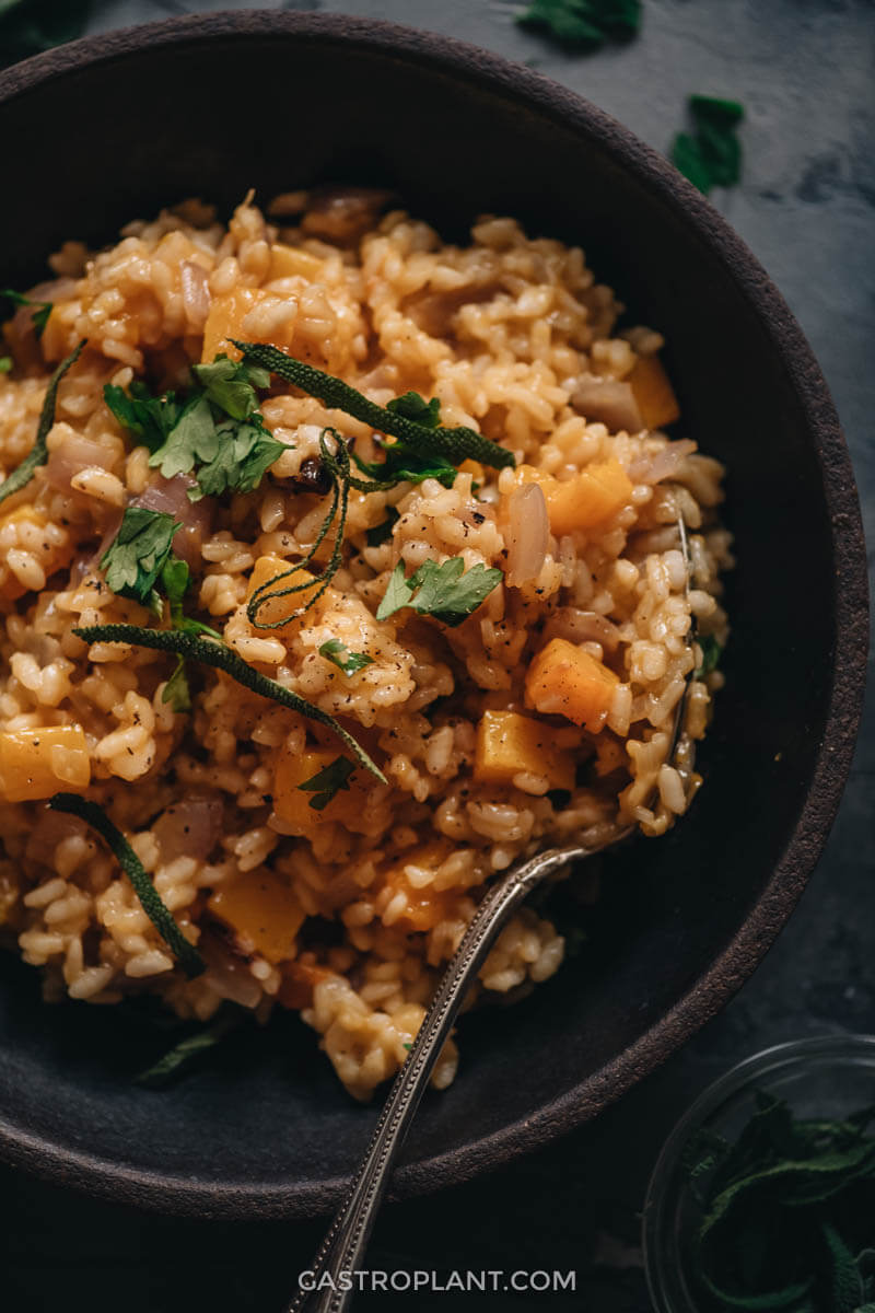 A close up shot of vegan butternut squash risotto seasoned wit nutmeg and sage