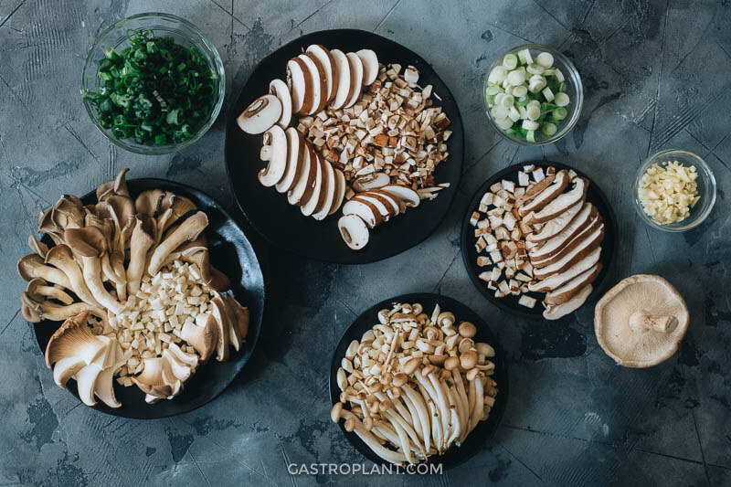 Four plates of slices mushrooms for fried rice