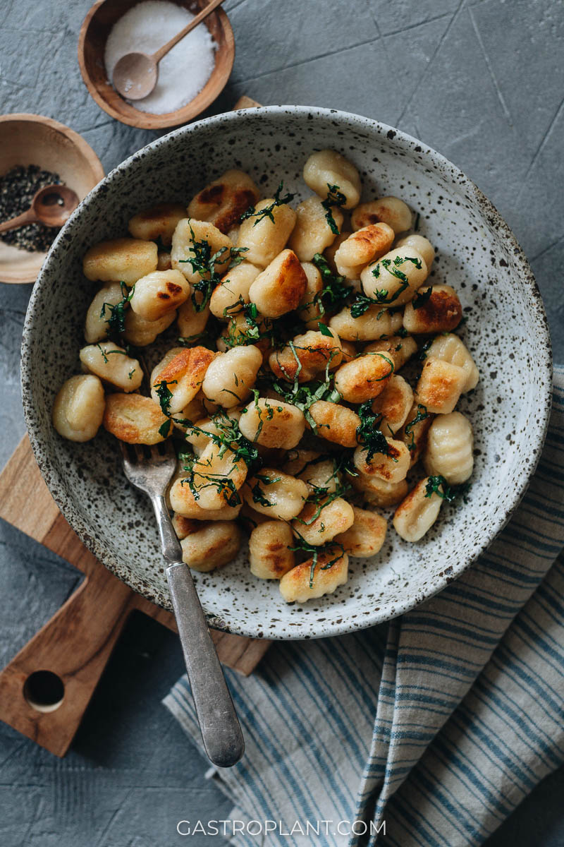 A bowl of homemade potato gnocchi sauteed with herbs
