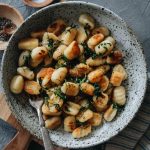A bowl of potato gnocchi sauteed with fresh herbs
