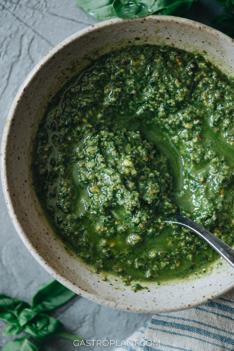 A bowl of bright green vegan basil pesto