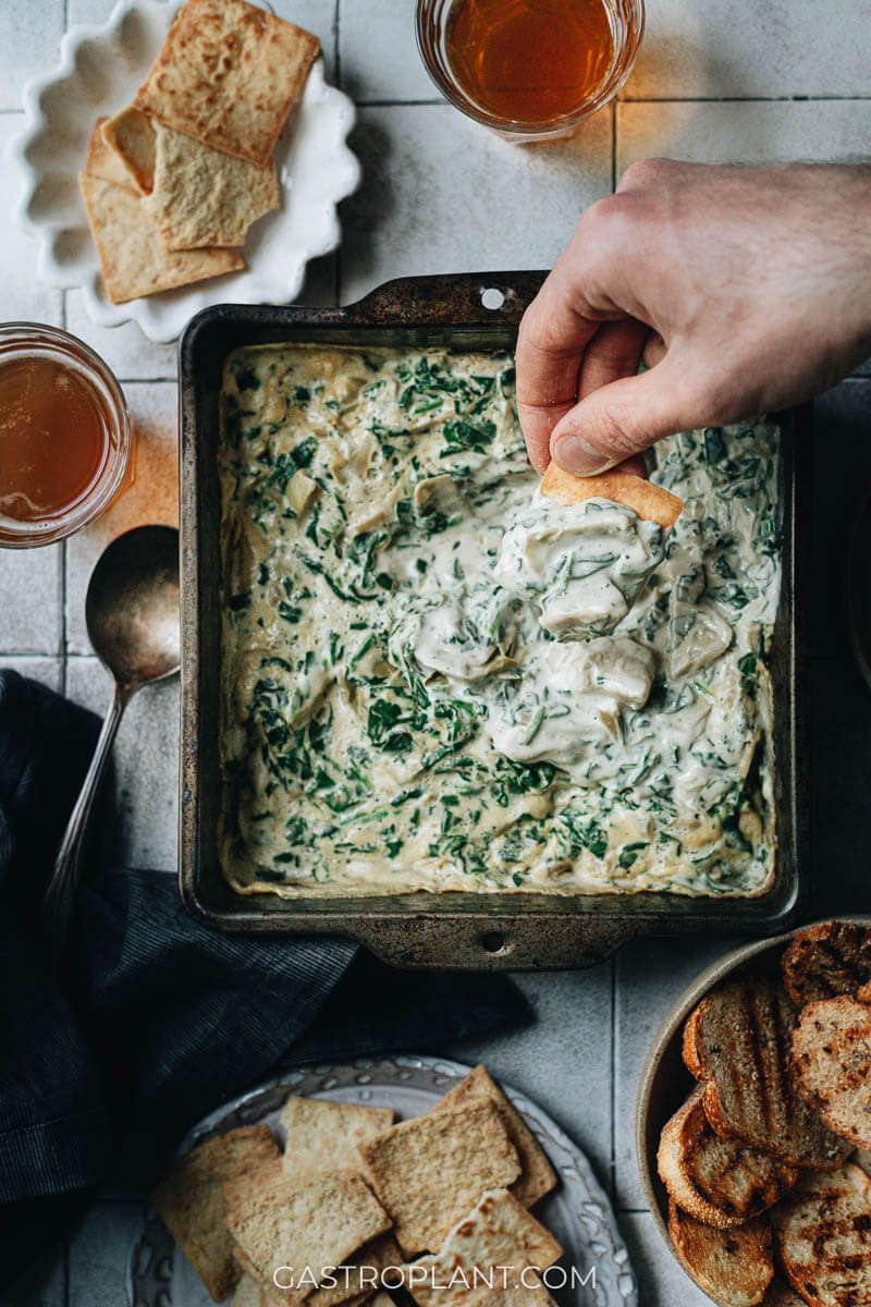 Plant-based spinach artichoke dip with pita chips