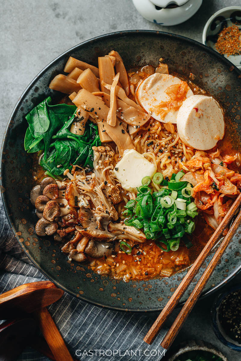 A bowl of spicy vegan kimchi ramen noodles with butter on top