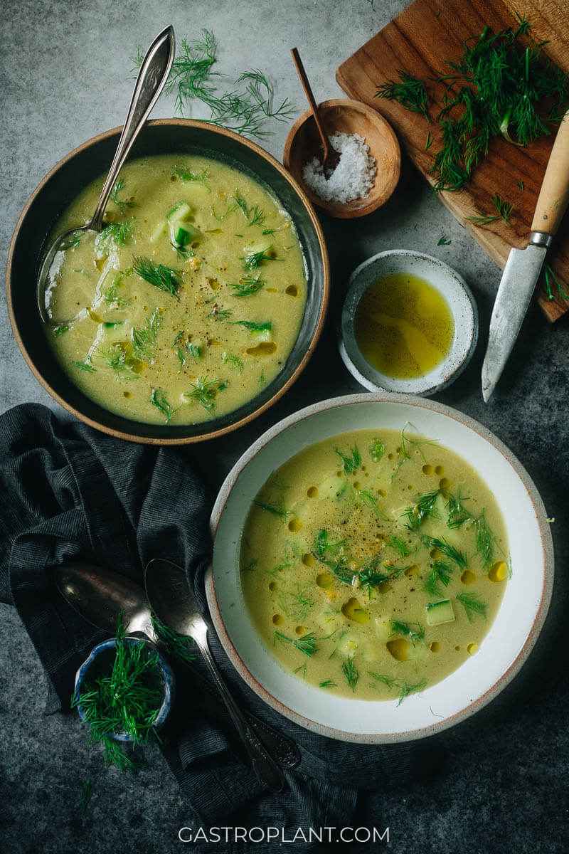 Two bowls, one black and one white, of chilled fennel soup