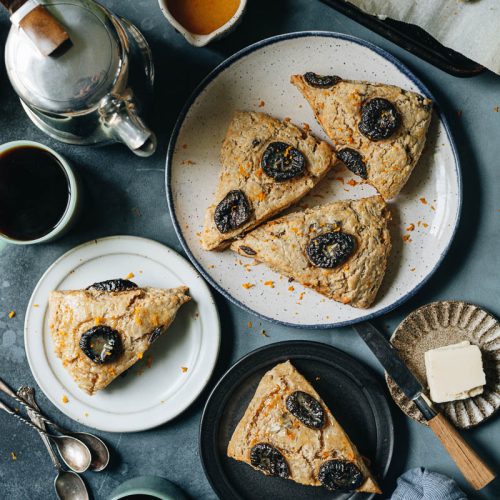 Orange and prune scones made from all vegan ingredients, spiced with cinnamon and nutmeg and served with coffee