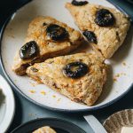 A close-up photo of orange and prune scones (vegan) made with less sugar and more spice