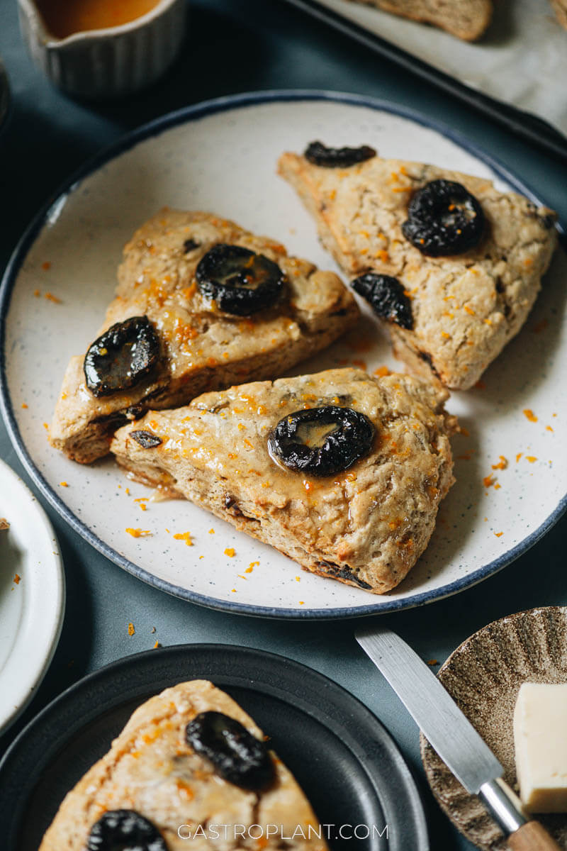 A close-up photo of orange and prune scones (vegan) made with less sugar and more spice